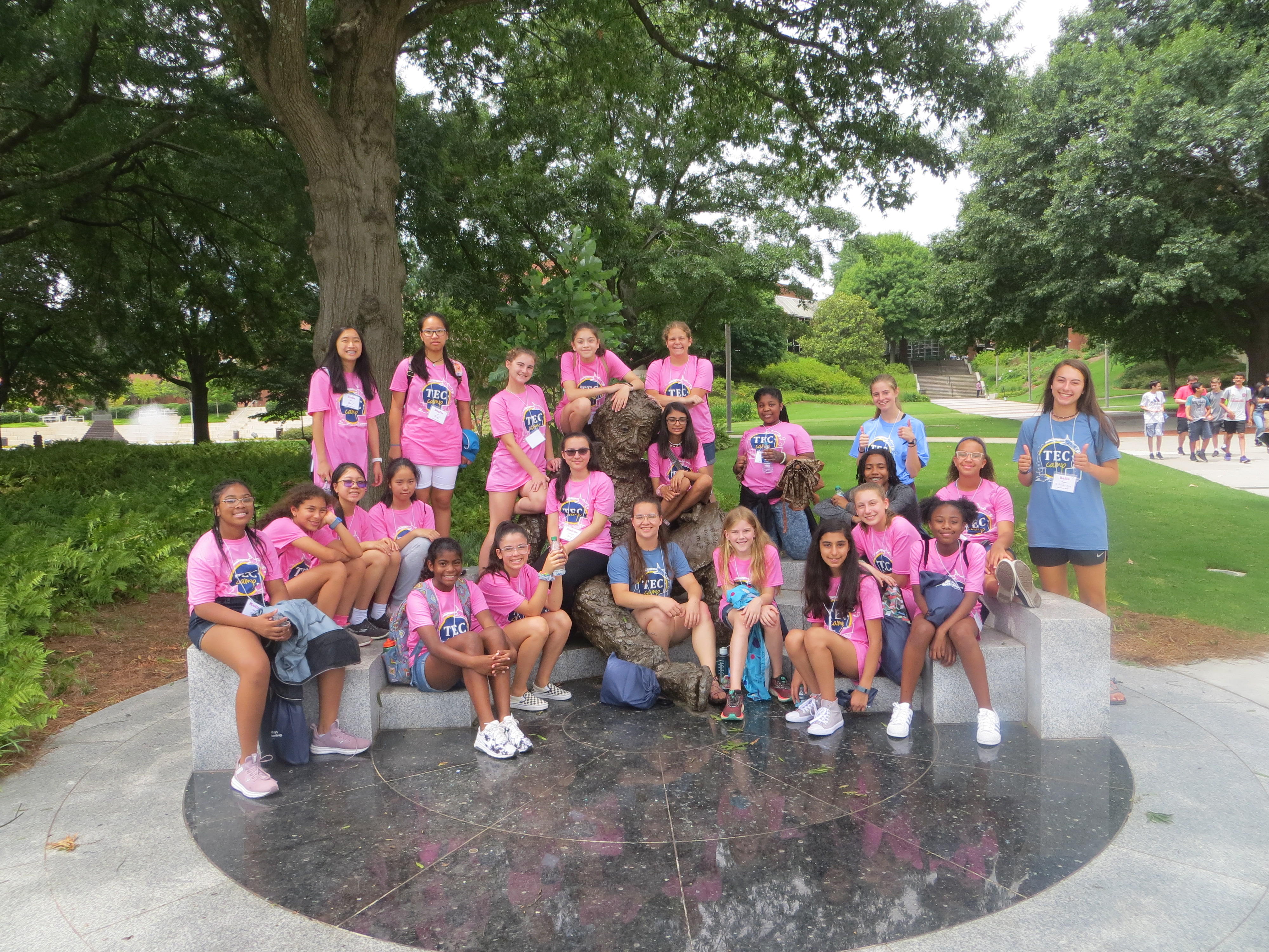 Group of campers with their counselors posing with the Einstein statue