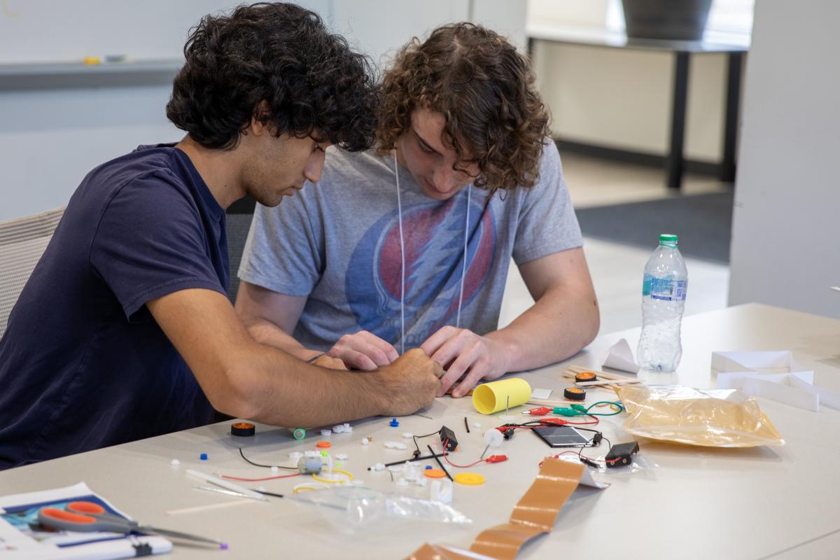 two students work on an engineering project